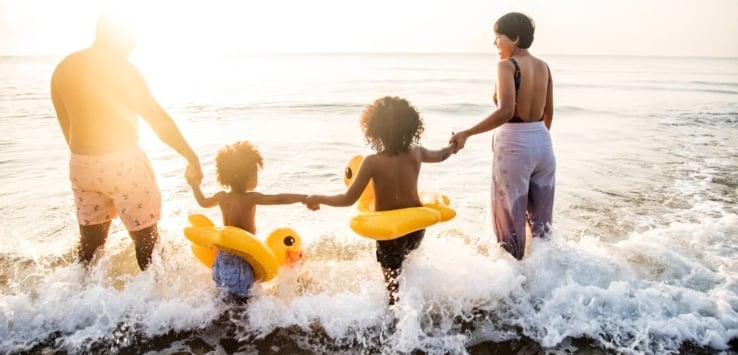 Black family having fun at beach