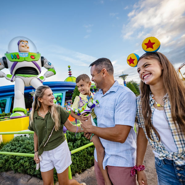 Family on vacation at Walt Disney World with Buzz Lightyear in background