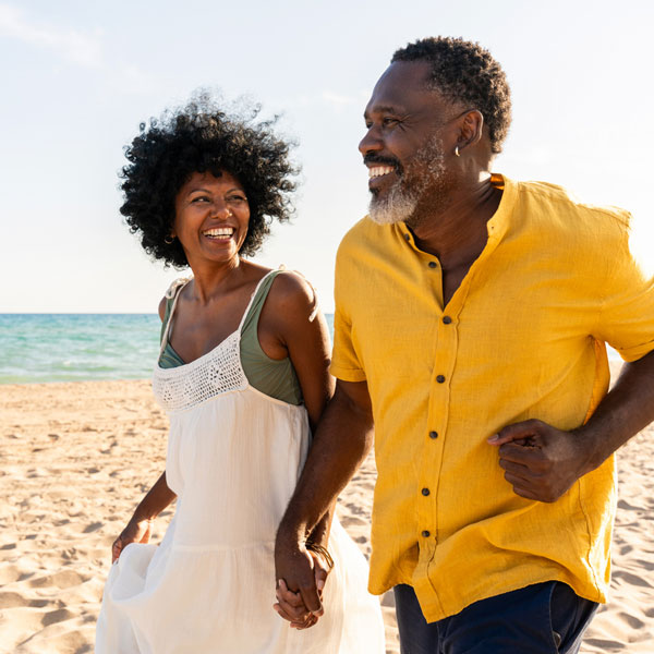 African American couple walking on the beach