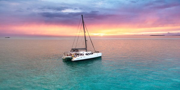 Catamaran boat during sunset